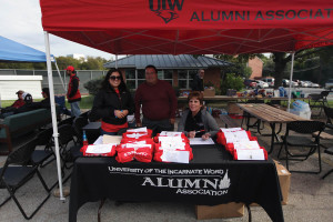 Alumni Board members Laurie Aguillon ’11 BBA, Steve Hemphill and Joan Shepack ’79 BSN setup the registration table for the Homecoming tailgate and BBQ.