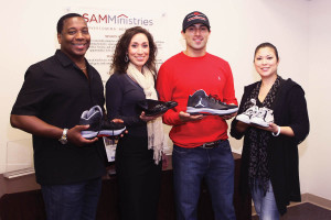 (Pictured L-R): Navarra R. Williams, president and CEO of SAMMinistries, Jessica Renee, co-founder of A Walk in My Shoes, Eric Castillo, UIW student and co-founder of A Walk in My Shoes, and Vanessa Rodriguez, volunteer to A Walk in My Shoes, display  onated shoes at the administrative offices of SAMMinistries.