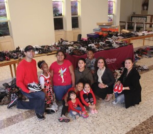 Castillo, Renee, and Rodriguez share a photo with children of families living at SAMMinistries Transitional Living and Learning Center.