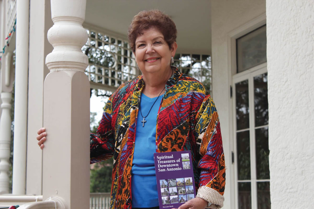 Mary Jane Hardy, holding her book “Spiritual Treasures of Downtown San Antonio,” poses for a photo at the Brackenridge Villa on the UIW campus.