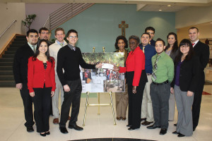 Former Chairman of the Dean’s Student Council Andrew Prado, along with the council and Dr. Johnson-Fannin, presents a check to fund the building of the well in Ghana to Kinard.