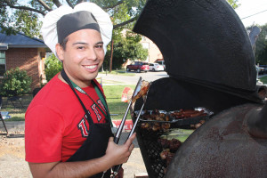 Jason Herrera ’09 BBA MS, alumni board events chairman, starts the Homecoming BBQ in style.