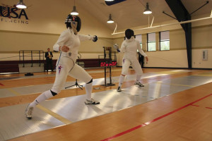 Olympians Courtney and Kelley Hurley perform a fencing demonstration at the grand opening event.