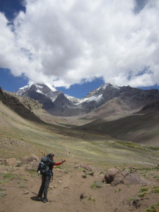 Samantha Magnum on her way to base camp. This is their first sight of Aconcagua, which took the party three days to see. The summit is hiding in the clouds with a view of The Polish Glacier.