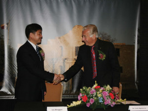 (Pictured L-R) Bingguo Liu, chairman and general manger of Yaqi Yantai Textile Co., Ltd., and Dr. Louis J. Agnese. Jr., UIW President, prepare to sign a memorandum of understanding at a ceremony held on April 22 at the Marriott Rivercenter Hotel.