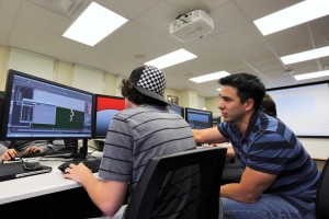 Tovar instructs a student during a 3-D animation class. 