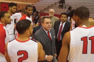 Head coach Ken Burmeister addresses the team during the Cardinals’ game against Huston –Tillotson University this season. 