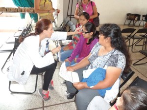 Fourth year RSO student Raelyn Ottenbreit evaluates patients in Oaxaca, Mexico.