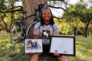 Skelton holds her photo with Obama and Biden at the White House as well as her service award. 