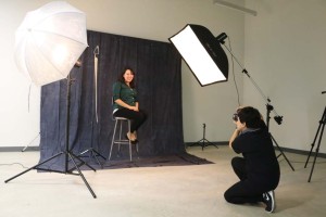 Students work in the lighting studio for photography.