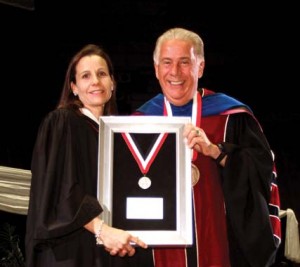 Dr. Louis Agnese, UIW president, presents Brune with the Alumni of Distinction award. 