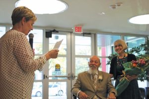 Light (left) says farewell to Norgan (center) as his wife looks on during Norgan’s retirement celebration in April. 