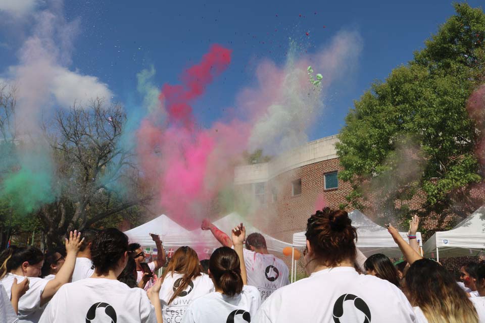 Students throw dye to celebrate the coming of spring. 