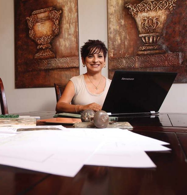 Preciado at work in a home she restored in San Antonio’s Dignowity Hill area.