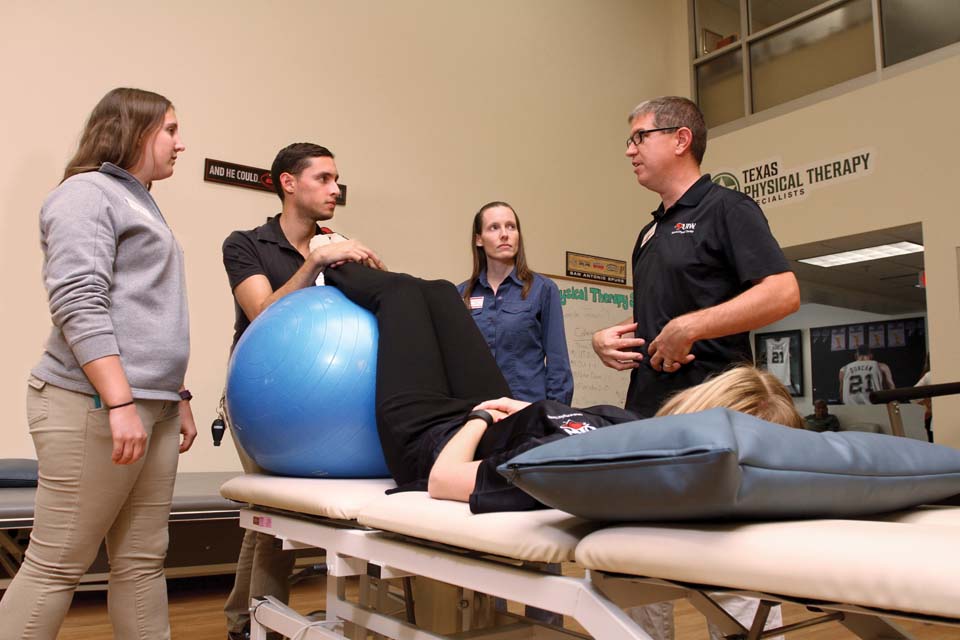 Crocker and PT students discuss patient care with Dr. Chad Jackson (right), assistant professor of PT, in the SoPT Community Clinic. 