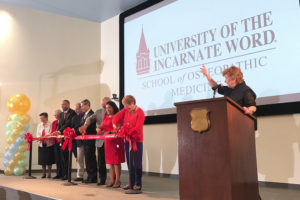 Sr. Kathleen Coughlin, CCVI, signals city leaders, physicians and faculty to cut the ribbon signaling the opening of the School of Osteopathic Medicine.