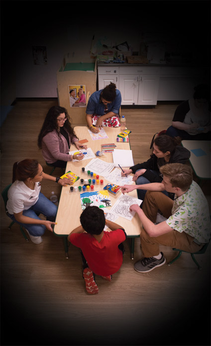 Student teachers work with children in the community as part of their education training.