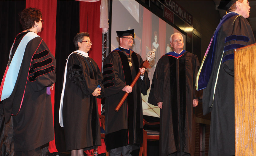 Sr. Teresa Maya, CCVI congregational leader, and Charles Lutz, president of the Board of Trustees presented Evans with the University mace and presidential medallion.