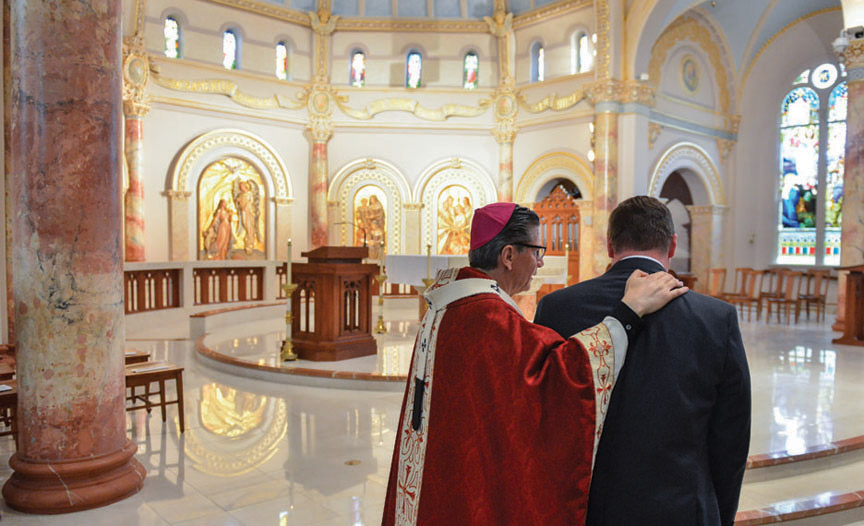 The Most Reverend Gustavo Garcia-Siller speaks with Evans at the Eucharistic Celebration.