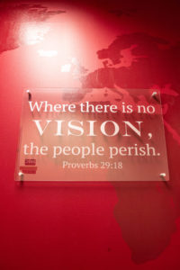 Mission Wall sign reads "Where there is no vision, the people perish," from Proverbs 29:18.