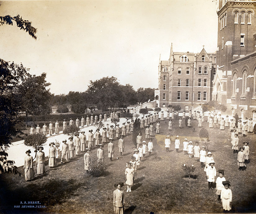 Students form the college acronym, IWC.